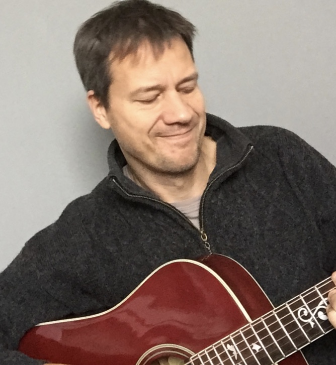 Kay playing guitar